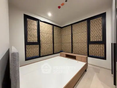 Modern bedroom with unique patterned wall panels and minimalist bed frame