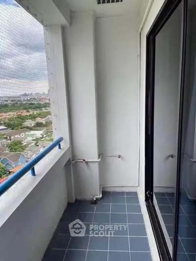 Spacious balcony with city view in modern high-rise apartment