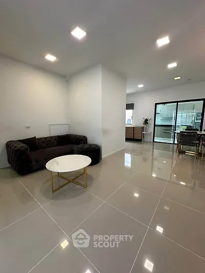 Spacious modern living room with elegant furniture and glossy tiled flooring