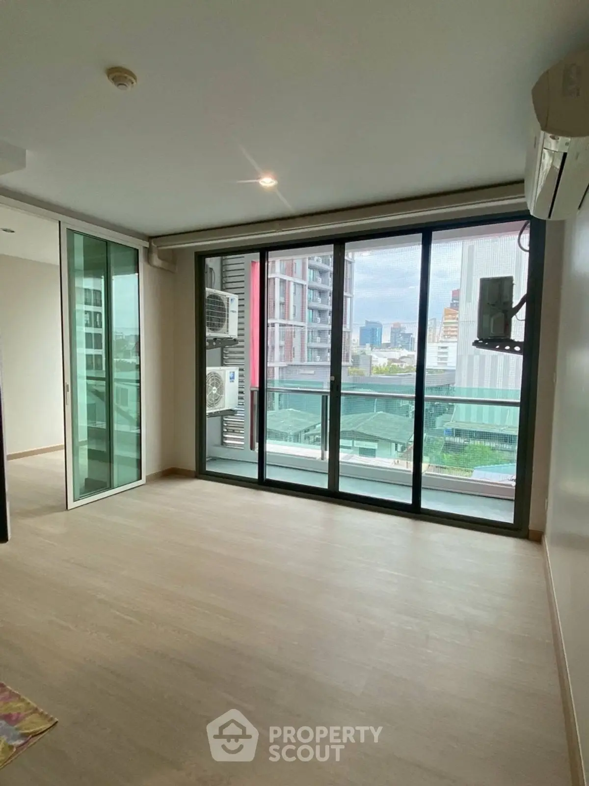 Spacious modern living room with large windows and city view