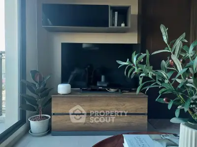 Modern living room with stylish TV setup and indoor plants