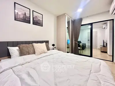Modern bedroom with cozy bedding and stylish decor in a contemporary apartment.