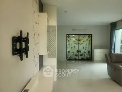 Spacious living room with elegant decor and large windows for natural light.