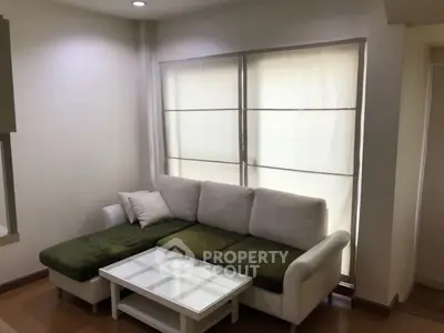 Cozy living room with stylish green and white sofa and modern coffee table