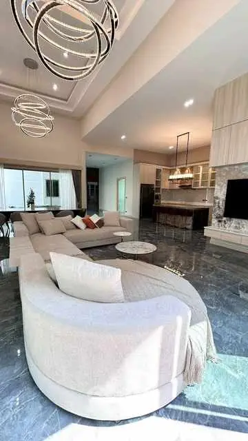Luxurious modern living room with elegant lighting and spacious seating area.