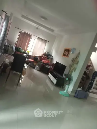 Spacious living room with modern decor and natural light, ideal for family gatherings.