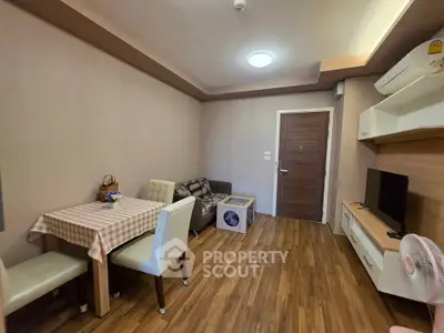 Cozy living room with modern furniture and wooden flooring in a stylish apartment.