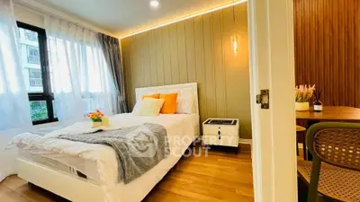 Cozy bedroom with modern decor, large window, and stylish lighting in a contemporary apartment.