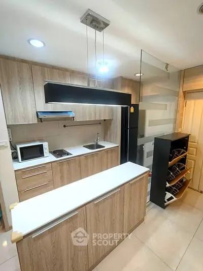 Modern kitchen with sleek wooden cabinets and open layout design