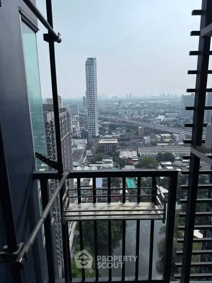 Stunning high-rise balcony view overlooking cityscape and river, perfect for urban living enthusiasts.