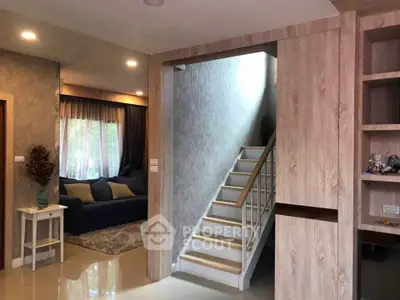 Modern living room with cozy seating and stylish staircase