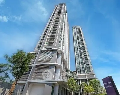Stunning high-rise residential building with modern architecture and lush surroundings.