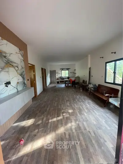 Spacious open-layout living room with modern design and natural light