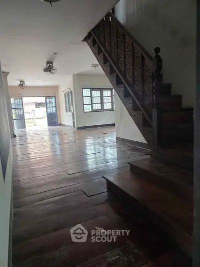 Spacious interior with wooden staircase and open layout, perfect for modern living.