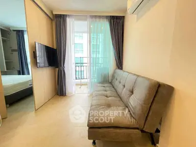 Modern living room with balcony access and stylish sofa in a contemporary apartment