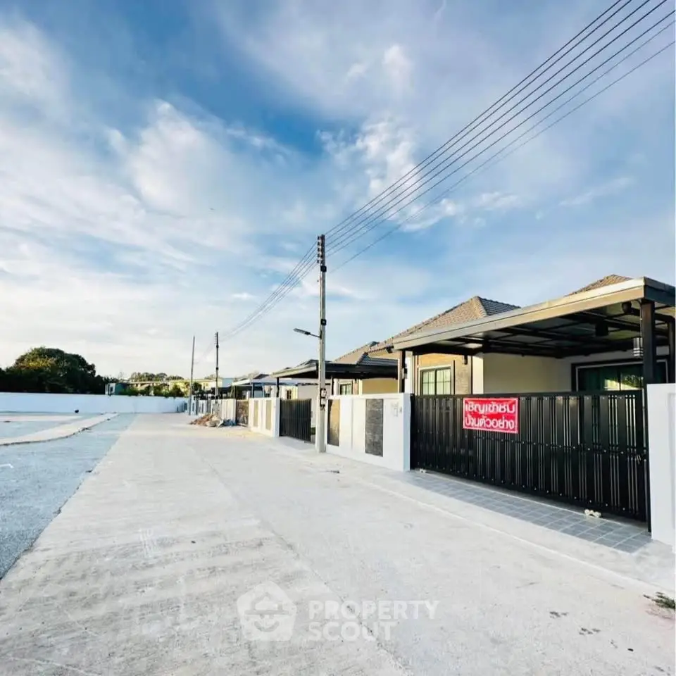 Modern single-story homes with sleek design and spacious driveways in a serene neighborhood.