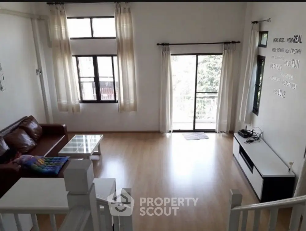 Spacious living room with modern decor and large windows for natural light.