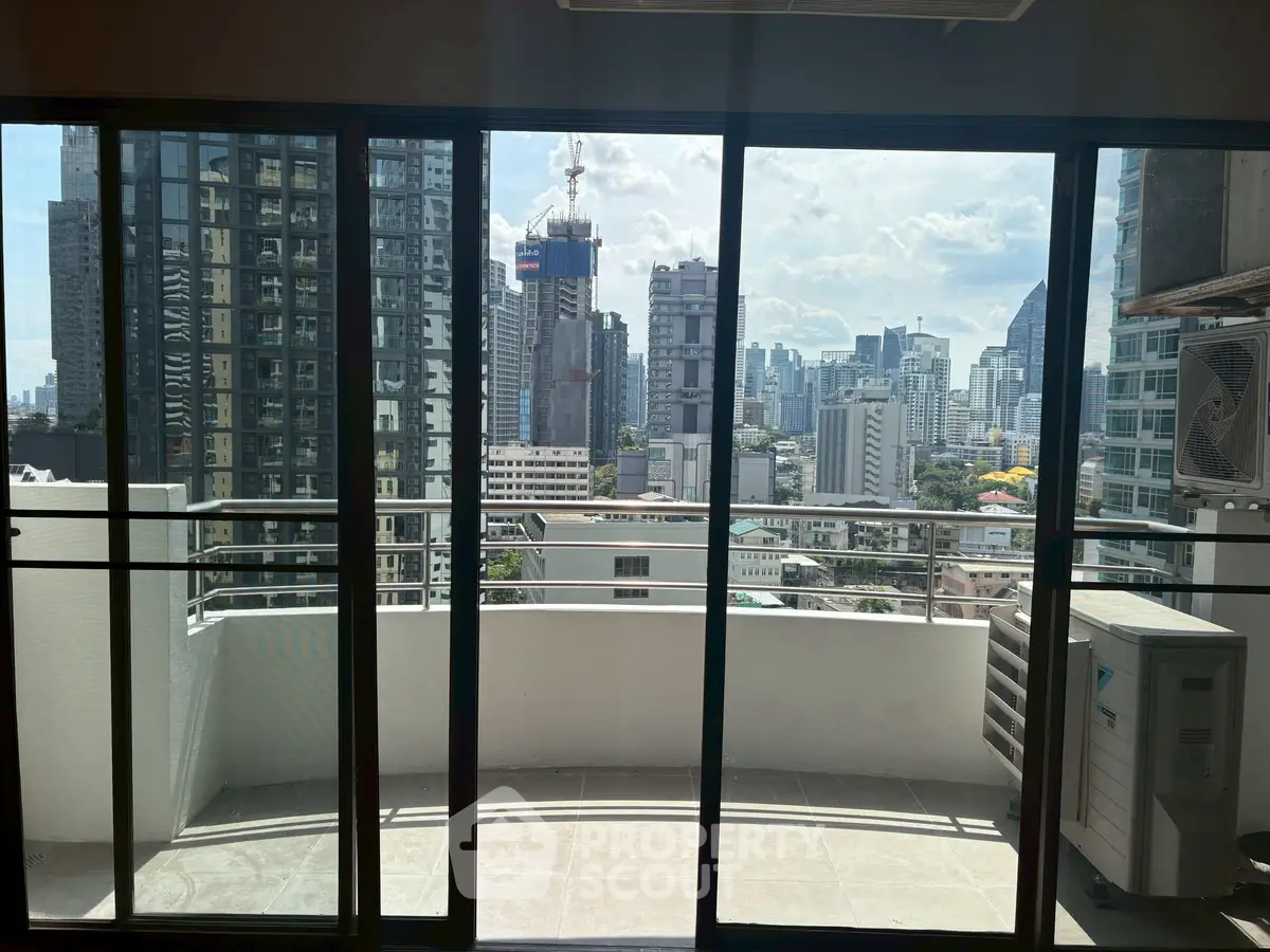 Spacious balcony with stunning city skyline view, perfect for urban living.