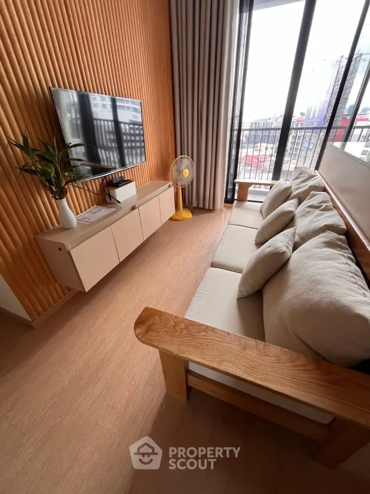 Modern living room with wooden accents and balcony view