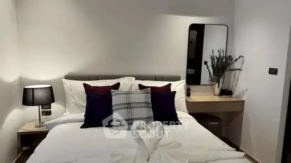 Cozy bedroom with elegant decor and swan towel art on bed