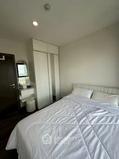 Modern bedroom with sleek wardrobe and cozy bed in a stylish apartment.