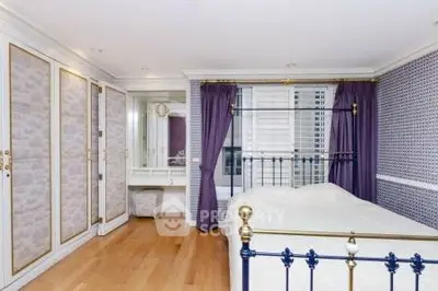 Elegant bedroom with classic decor and luxurious bed in a stylish apartment.