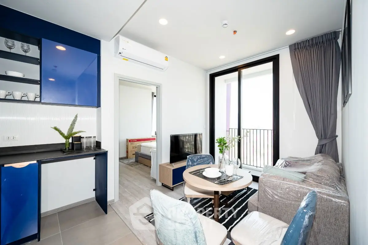 Modern living room with balcony in stylish apartment, featuring sleek furniture and open layout.