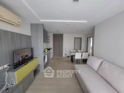 Modern living room with sleek furniture and open kitchen layout, perfect for contemporary living.