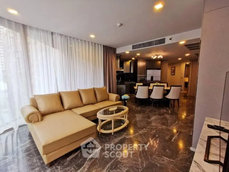 Luxurious open-plan living room with elegant marble flooring and modern furnishings.