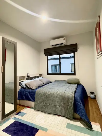 Cozy bedroom with modern decor and ample natural light