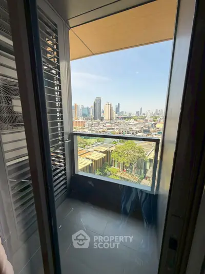 Stunning city view from a modern apartment balcony with sleek design and ample natural light.