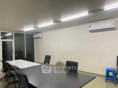 Spacious office space with modern furniture and air conditioning, ideal for productivity and comfort.