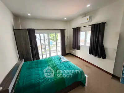 Spacious bedroom with modern decor and balcony access