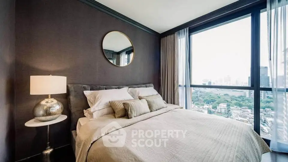 Luxurious bedroom with city view, elegant decor, and ample natural light.
