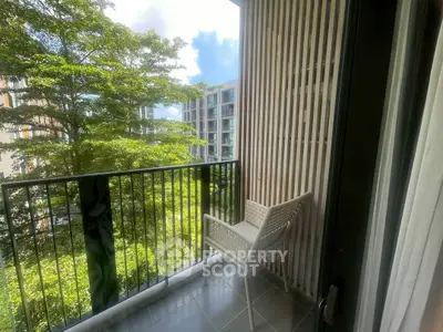 Charming balcony with lush greenery view in modern apartment complex.