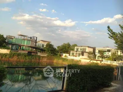 Luxurious waterfront villas with modern architecture and lush greenery