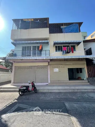 Charming multi-story building with street-level commercial space and upper residential units, ideal for mixed-use investment.