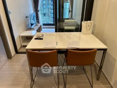 Modern apartment interior with sleek dining area and view of living room, showcasing contemporary urban living.
