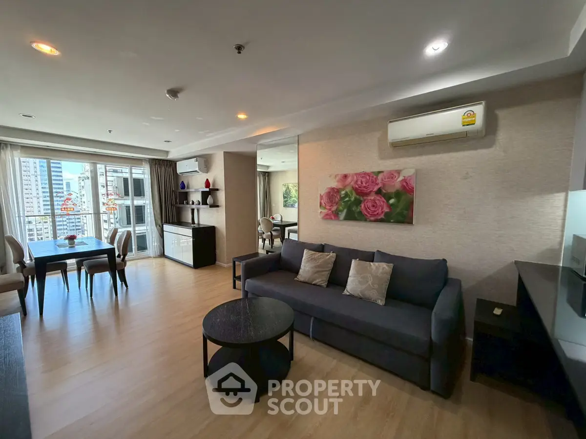 Spacious modern living room with elegant decor and city view, perfect for urban living.