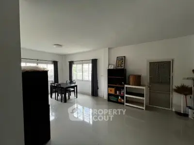 Spacious living area with modern decor and large windows for natural light.