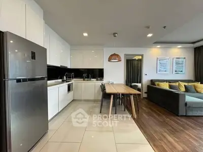 Modern open-plan kitchen and living room with sleek design and ample natural light.