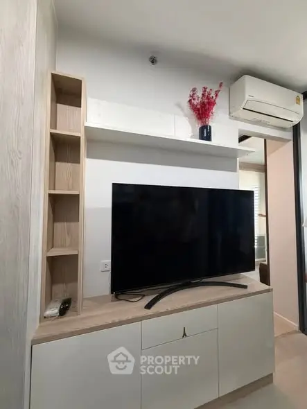 Modern living room with sleek TV unit and air conditioning, perfect for cozy entertainment.