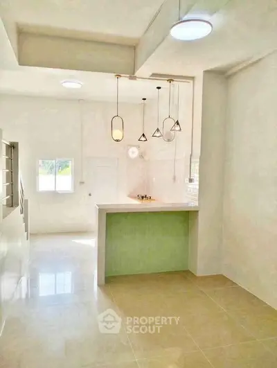 Bright modern kitchen with stylish pendant lights and open layout