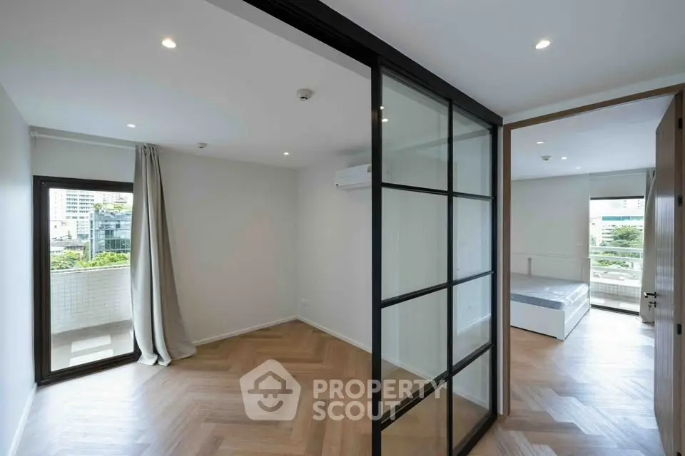 Modern apartment interior with glass partition and herringbone flooring