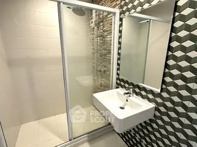 Modern bathroom with sleek shower and stylish sink in contemporary design.