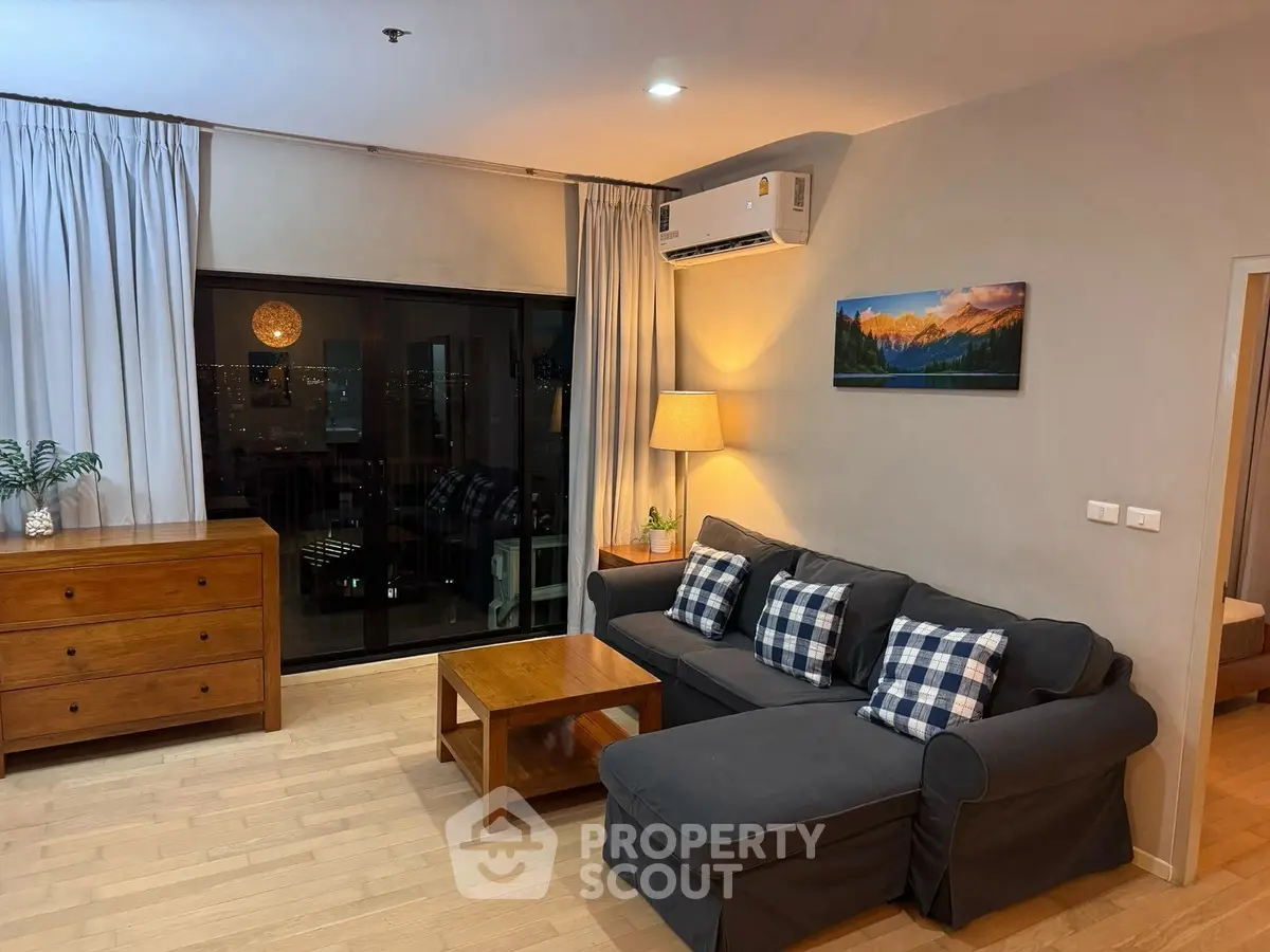 Cozy living room with city view, modern furniture, and warm lighting