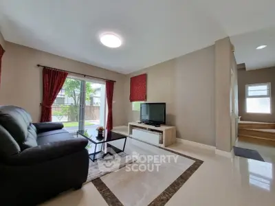 Spacious living room with modern decor and large window view