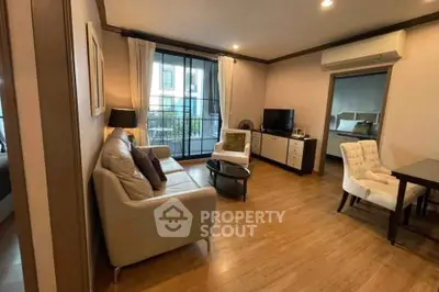 Spacious living room with modern furniture and large window in a stylish apartment.