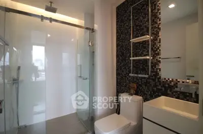 Modern bathroom with glass shower and stylish mosaic wall tiles