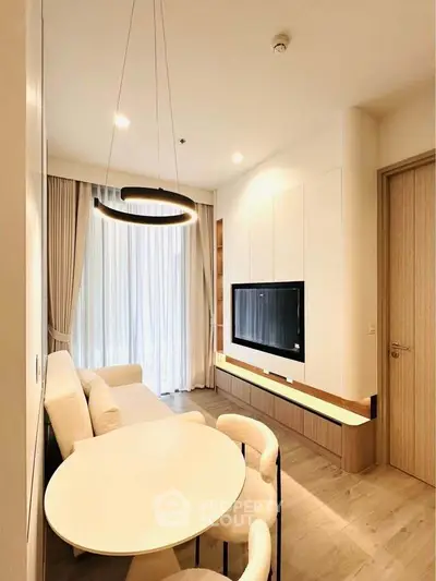 Modern living room with elegant lighting and cozy seating area, perfect for relaxation and entertainment.